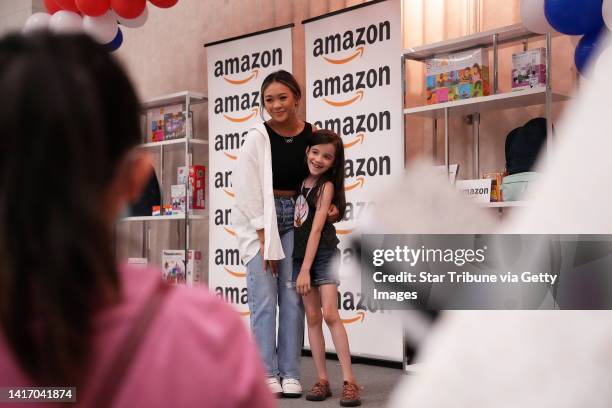 Olympic gold medal winning gymnast Suni Lee poses for photos with students during a back-to-school donation event with Amazon to donate $50,000 in...