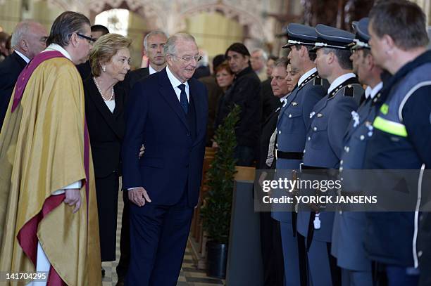 Queen Paola of Belgium and King Albert II of Belgium greet the Swiss emergency services on March 22, 2012 at the Sint-Pieters church in Leuven during...