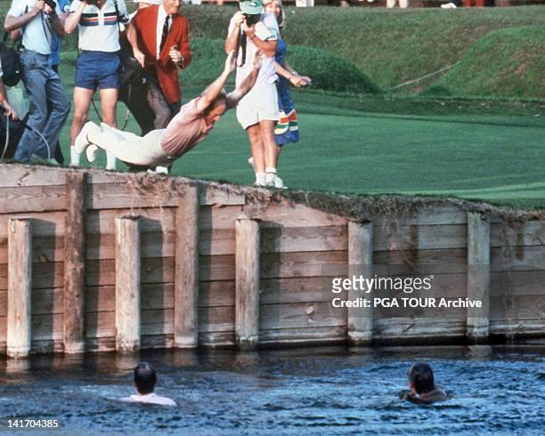 Jerry Pate jumps into the water hazard on the 18th hole after winning THE PLAYERS Championship held at THE PLAYERS Stadium course at TPC Sawgrass on...
