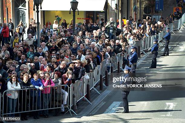 People gather on March 22, 2012 outside the Sint-Pieters church in Leuven during the funeral service of the seven children from Heverlee, who were...