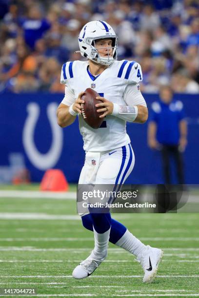 Sam Ehlinger of the Indianapolis Colts looks to pass the ball in the preseason game against the Detroit Lions at Lucas Oil Stadium on August 20, 2022...