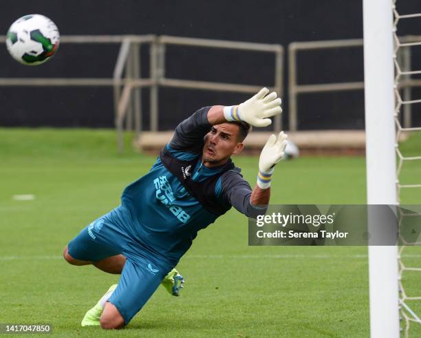 Goalkeeper Karl Darlow dives save the ball during the Newcastle United Training Session at the Newcastle United Training Ground on August 22, 2022 in...