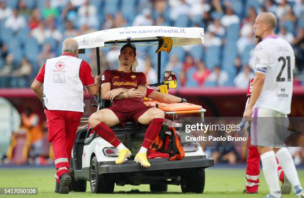 Nicolo Zaniolo of AS Roma leaves the field on a Golf Buggy after suffering an injury during the Serie A match between AS Roma and US Cremonese at...