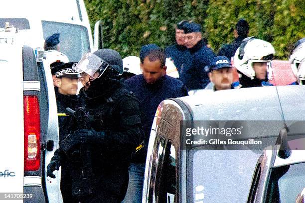 Police and members of the emergency services surround the property during an operation to arrest suspected gunman Mohammed Merah on March 22, 2012 in...