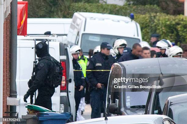 Police and members of the emergency services surround the property during an operation to arrest suspected gunman Mohammed Merah on March 22, 2012 in...