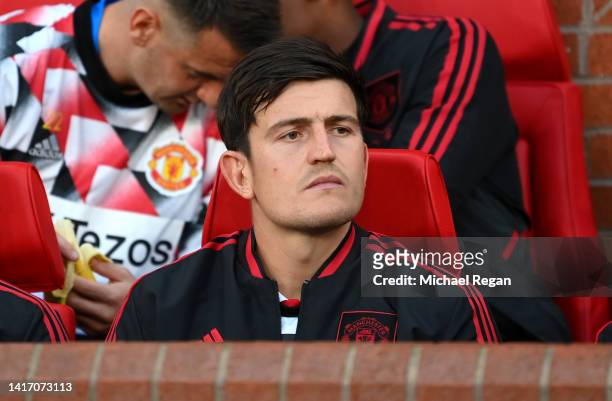 Harry Maguire of Manchester United looks on from the substitutes bench prior to the Premier League match between Manchester United and Liverpool FC...