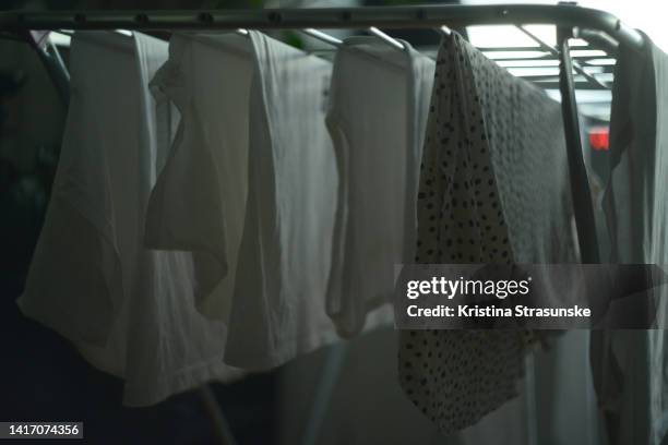 clothes in white color hanging on a drying rack for drying - 乾かす ストックフォトと画像