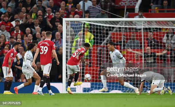 Jadon Sancho of Manchester United scores their side's first goal during the Premier League match between Manchester United and Liverpool FC at Old...