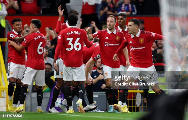 Jadon Sancho of Manchester United celebrates with teammates after scoring their side's first goal during the Premier League match between Manchester...