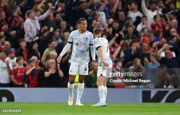 James Milner of Liverpool interacts with teammate Virgil van Dijk after the Manchester United first goal scored by Jadon Sancho during the Premier...