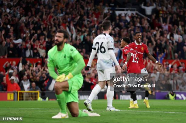Jadon Sancho of Manchester United celebrates with teammate Marcus Rashford after scoring their side's first goal as Alisson Becker of Liverpool looks...