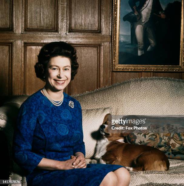 Queen Elizabeth II with one of her corgis at Sandringham, 1970.