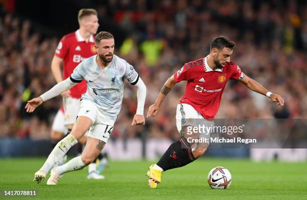 Bruno Fernandes of Manchester United is closed down by Jordan Henderson of Liverpool during the Premier League match between Manchester United and...