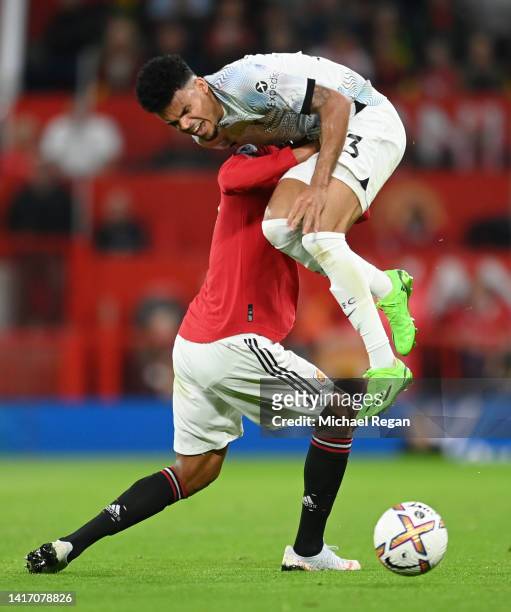 Luis Diaz of Liverpool is challenged by Raphael Varane of Manchester United during the Premier League match between Manchester United and Liverpool...