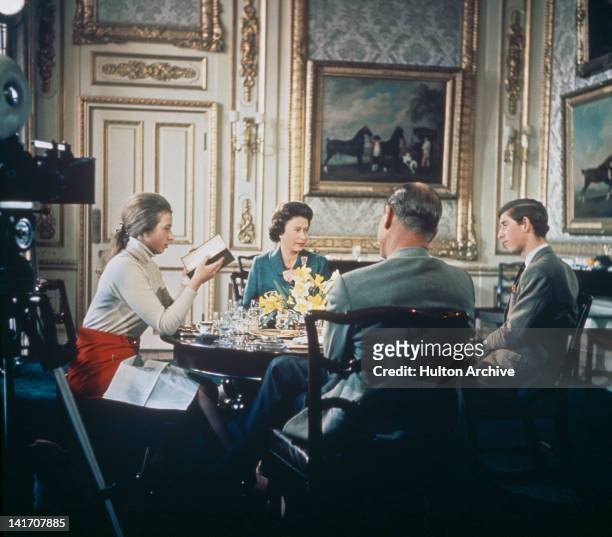 Queen Elizabeth II lunches with Prince Philip and their children Princess Anne and Prince Charles at Windsor Castle in Berkshire, circa 1969. A...