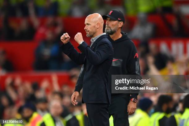 Erik ten Hag, Manager of Manchester United celebrates victory as Juergen Klopp, Manager of Liverpool looks on following the Premier League match...