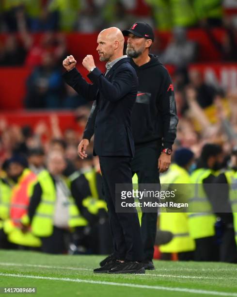 Erik ten Hag, Manager of Manchester United celebrates victory as Juergen Klopp, Manager of Liverpool looks on following the Premier League match...