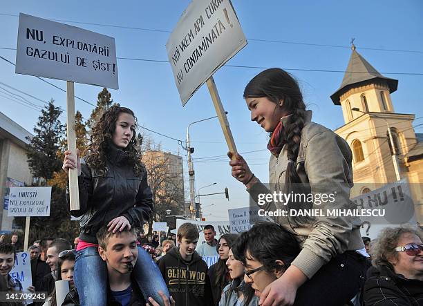 Romanian girls holds placards reading in Romanian "NO to the shale gas exploition" and "We want clean water, not contaminated" during a protest in...