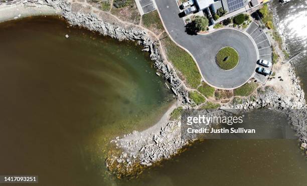 In an aerial view, brownish streaks from an algal bloom are visible in the water in the San Francisco Bay on August 22, 2022 in Alameda, California....
