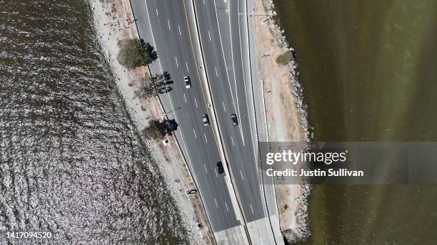 In an aerial view, cars drive on the Richmond-San Rafael Bridge over brownish water from an algal bloom in the San Francisco Bay on August 22, 2022...