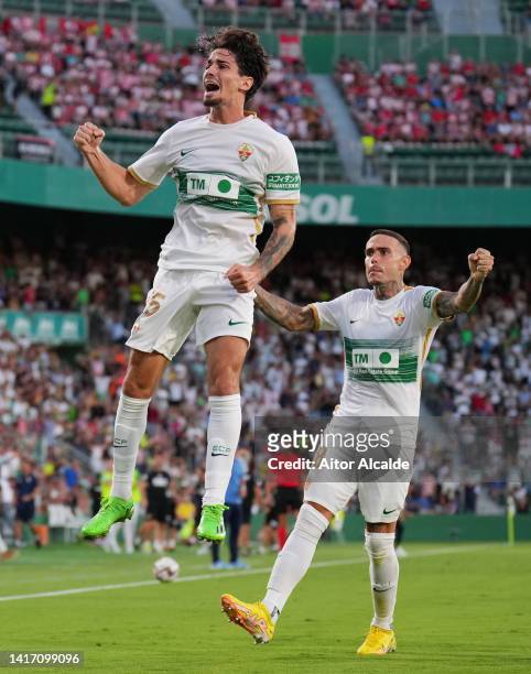 Alex Collado of Elche celebrates with teammates after scoring their side's first goal during the LaLiga Santander match between Elche CF and UD...