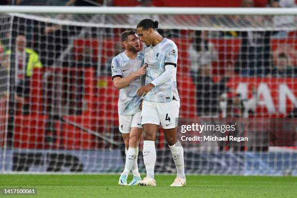 James Milner of Liverpool interacts with teammate Virgil van Dijk after the Manchester United first goal scored by Jadon Sancho during the Premier...