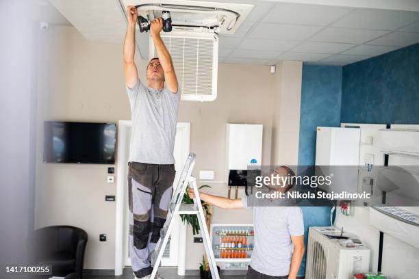 airconditioning maintenance - air conditioner installation stock pictures, royalty-free photos & images