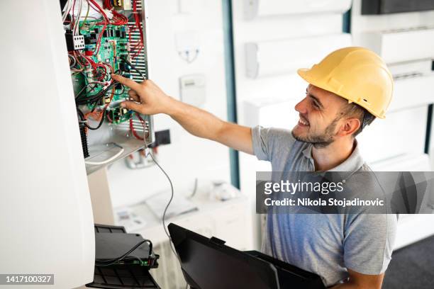 soldering copper pipes during ac installation - happiness meter stock pictures, royalty-free photos & images