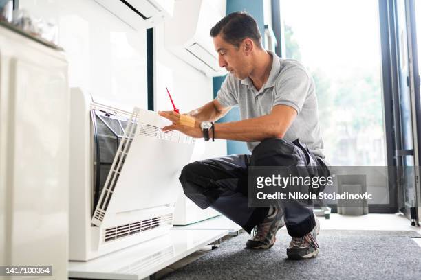 technician cleaning air conditioner filter - air duct repair stock pictures, royalty-free photos & images