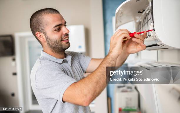 technician cleaning air conditioner filter - cleaning walls stock pictures, royalty-free photos & images