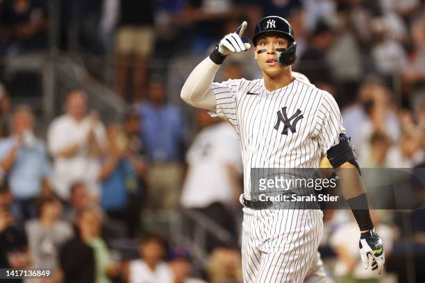 Aaron Judge of the New York Yankees reacts after hitting a home run during the third inning against the New York Mets at Yankee Stadium on August 22,...