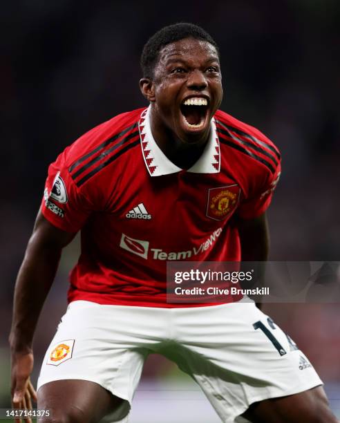 Tyrell Malacia of Manchester United celebrates after his team mate Jadon Sancho has scored their first goal during the Premier League match between...