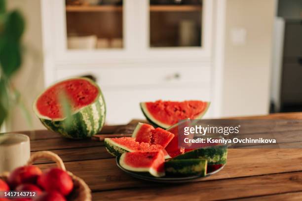 watermelon on table in kitchen - melone stock-fotos und bilder