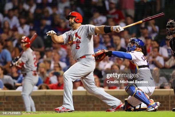 Albert Pujols of the St. Louis Cardinals hits a solo home run during the seventh inning off Drew Smyly of the Chicago Cubs at Wrigley Field on August...