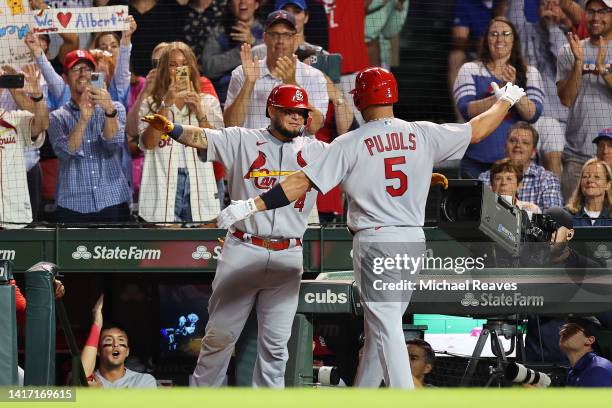 Albert Pujols of the St. Louis Cardinals celebrates his solo home run with Yadier Molina against the Chicago Cubs during the seventh inning at...
