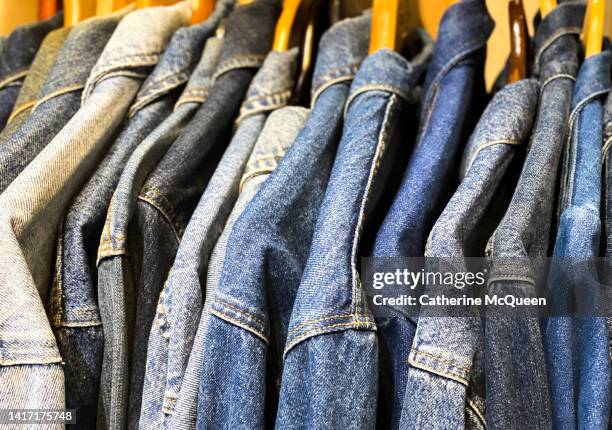 hanging rack of vintage denim jackets - denim store stock pictures, royalty-free photos & images