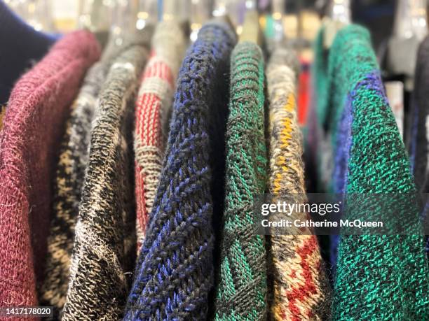 clothing rack of vintage sweaters at flea market - knit fashion stock pictures, royalty-free photos & images