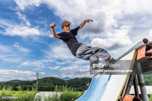 skateboarder doing a trick on a half pipe - half pipe stock pictures, royalty-free photos & images