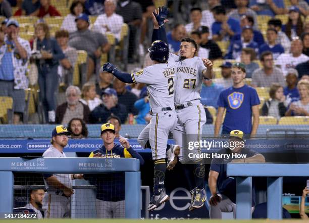 Luis Urias of the Milwaukee Brewers celebrates his solo homerun with Willy Adames, to take a 1-0 lead over the Los Angeles Dodgers during the fourth...