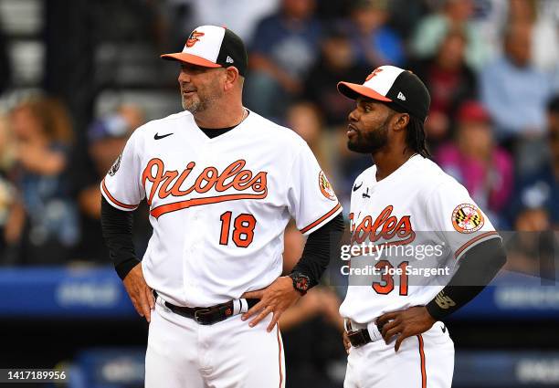 Brandon Hyde and Austin Hays of the Baltimore Orioles talk prior to the game against the Boston Red Sox at Bowman Field on August 21, 2022 in South...