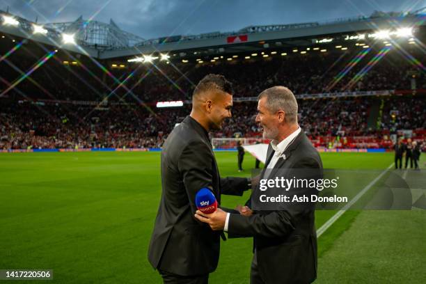 Casemiro of Manchester United greets Roy Keane ahead of the Premier League match between Manchester United and Liverpool FC at Old Trafford on August...