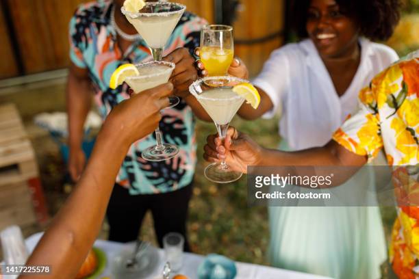 friends cheering with margarita cocktails during a garden summer party - summer cocktails garden party drinks bildbanksfoton och bilder