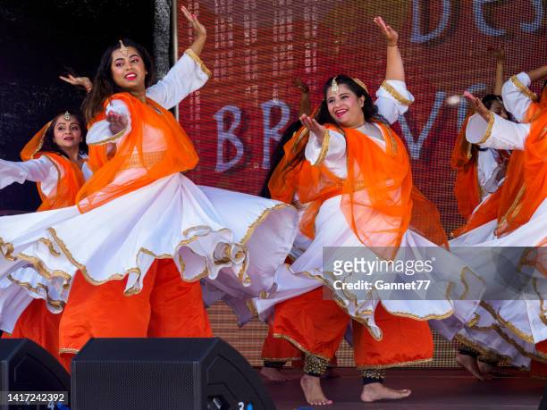 dancers performing at the aberdeen mela one-world day event - mela stock pictures, royalty-free photos & images