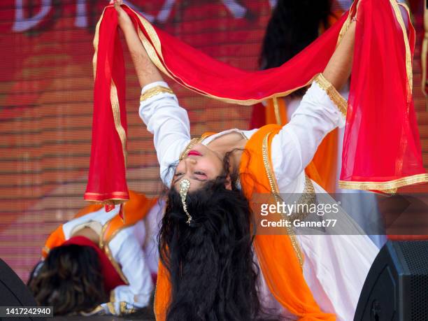 dancers performing at the aberdeen mela one-world day event - mela stock pictures, royalty-free photos & images