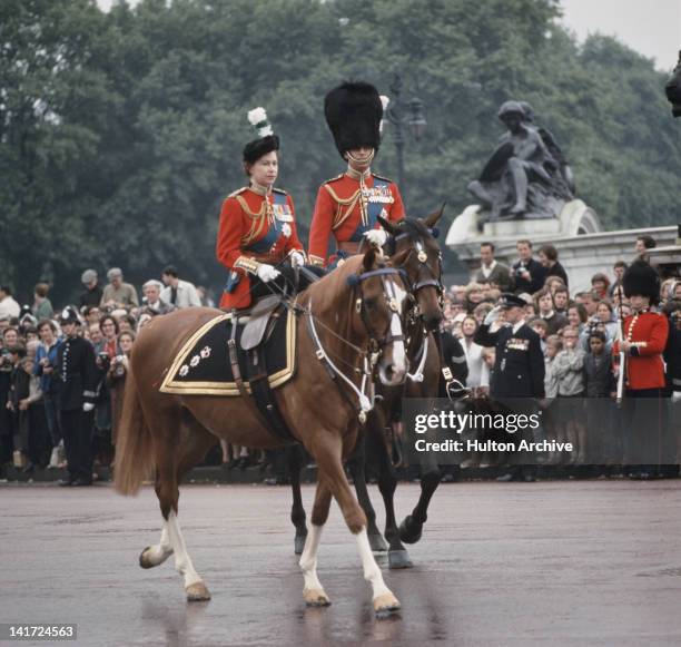 Queen Elizabeth II and Prince Philip return to Buckingham Palace in London after the Trooping The Colour ceremony, 12th June 1965.