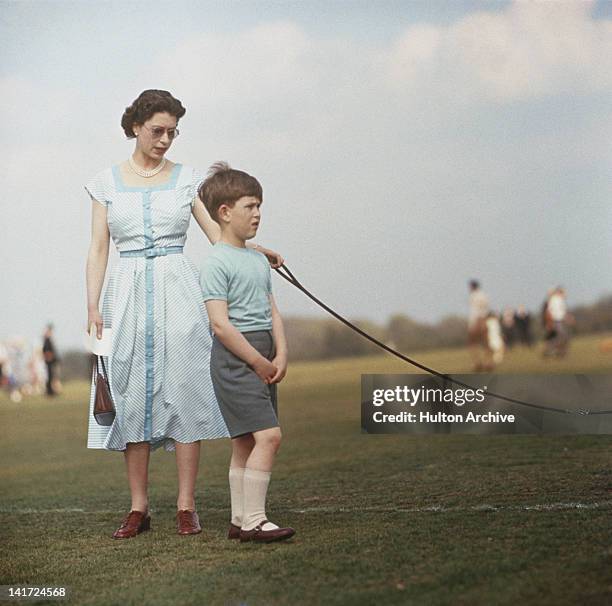Queen Elizabeth II with Prince Charles at Windsor Great Park, during a polo match, 1956.