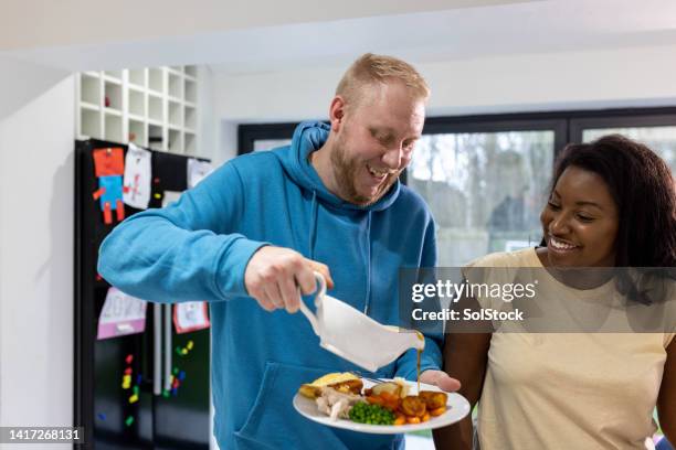 pouring gravy onto a roast dinner - gravy stock pictures, royalty-free photos & images