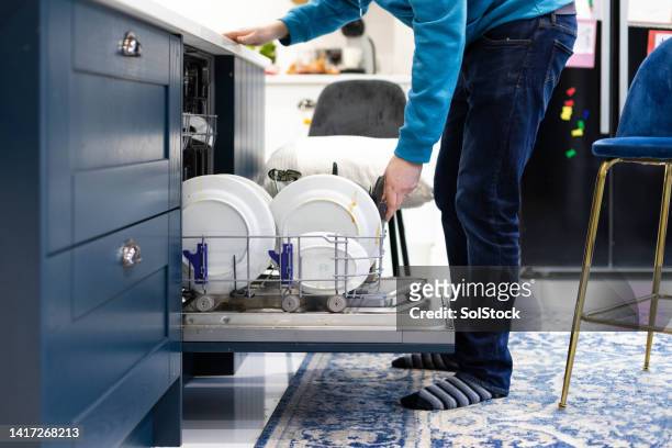 open dishwasher filled with dirty plates - men bulge imagens e fotografias de stock