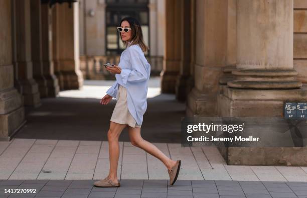 Elise Seitz seen wearing white Celine sunglasses, a light blue SohoStudios shirt, a creme beige shorts from SohoStudios and beige suede Birkenstock...