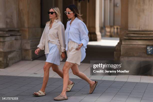 Anne Philine seen wearing black Celine sunglasses, a creme beige shirt from SohoStudios, light blue SohoStudios shorts and creme white suede...